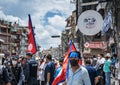 Man in mask moving with flag of Nepal, on background of police and protesters against corruption