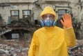 Man with mask and protective clothes explores danger area r Royalty Free Stock Photo