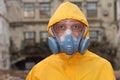 Man with mask and protective clothes explores danger area r Royalty Free Stock Photo