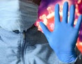 Man in a mask and protective gloves on the background of the image of a coronavirus. Doctor with a vaccine and a syringe