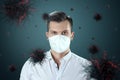 A man in a mask protects himself from virus particles flying in the air. Coronavirus, COVID-19, isolation, quarantine, pandemic Royalty Free Stock Photo