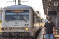 Man with a mask waiting for a train during Covid19 pandemic