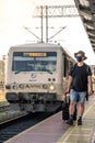 Man with a mask waiting for a train during Covid19 pandemic
