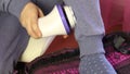 A man massages the calf muscles with an electric massager. Turns off the massager. Close-up shot