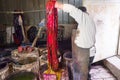 Man master paints Eastern, Turkish silk women`s scarves, shawls in a barrel of paint, texture, background, pattern