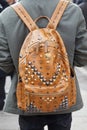 Man with MCM leather backpack with studs before Cristiano Burani fashion show, Milan Fashion Week street