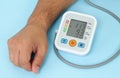 Man measures his blood pressure by electronic tonometer close-up Royalty Free Stock Photo