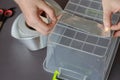 A man measures the length of a piece of aluminum tape over the b