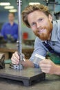 Man measures part accuracy by dial guage Royalty Free Stock Photo