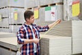 Man measures with roulette drywall sheets in store building mate Royalty Free Stock Photo