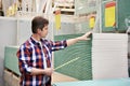 Man measures with roulette drywall sheets in store building mate Royalty Free Stock Photo