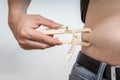 Man is measuring body fat on his belly with caliper Royalty Free Stock Photo