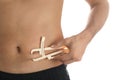 Man measuring body fat layer with caliper on background, closeup. Nutritionist`s tool