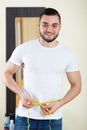 Man measuring body Royalty Free Stock Photo