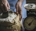 Man measuring the flour by the weighting scale Royalty Free Stock Photo