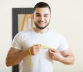 Man measuring his bicep and body Royalty Free Stock Photo