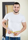 Man measuring his bicep and body Royalty Free Stock Photo