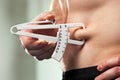 Man is measuring his body fat with calipers. Royalty Free Stock Photo