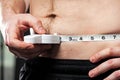 Man measuring his waist. Royalty Free Stock Photo