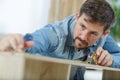 man measuring kitchen furniture indoors closeup
