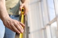 Man measuring metal railing, closeup view. Construction tool