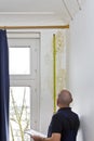 man measuring mold mildew stain wall Royalty Free Stock Photo