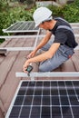 Man worker mounting solar panels on roof of house. Royalty Free Stock Photo