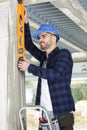 man measuring wall with construction level Royalty Free Stock Photo