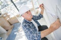 Man measuring wall nefore renovation Royalty Free Stock Photo