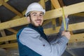 man measuring wood ceiling with tape measure Royalty Free Stock Photo