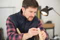 man measuring wood piece for furniture assembling Royalty Free Stock Photo