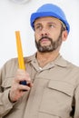 man measuring wood on saw