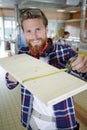 Man measuring wood with tape measure Royalty Free Stock Photo