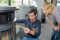 Man measuring woodburner on display Royalty Free Stock Photo