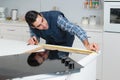 Man measuring worktop for installation hob