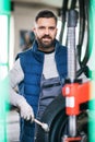 Man mechanic repairing a car in a garage. Royalty Free Stock Photo