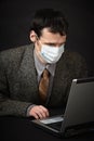 Man in medical mask diagnoses computer Royalty Free Stock Photo