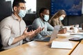 Man in medical mask having video call talking with client Royalty Free Stock Photo