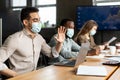 Man in medical mask having video call waving to webcam Royalty Free Stock Photo