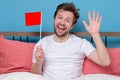 Man with medical mask holding small empty flag celebrating the end of quarantine