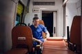 Man in a medical uniform sitting in the ambulance car and smiling Royalty Free Stock Photo