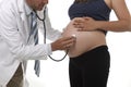 Man in medicine doctor coat using stethoscope listening to fetus Royalty Free Stock Photo