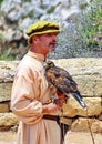 Man in Medieval Costume Holding a Hawk Bird