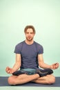 Man meditate on yoga mat. Sportsman relax in lotus pose. Fashion athlete practice yoga in gym. Meditation for body and Royalty Free Stock Photo