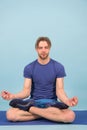 Man meditate on yoga mat. Sportsman relax in lotus pose. Fashion athlete practice yoga in gym. Meditation for body and Royalty Free Stock Photo