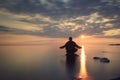 Man meditates on lake water Royalty Free Stock Photo