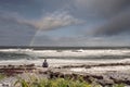 Man meditating on a beach by the ocean with stunning nature background. Dealing with stress of life and letting troubles go. Yoga Royalty Free Stock Photo