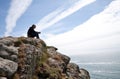 Man meditating on cliff top Royalty Free Stock Photo