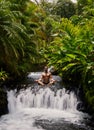 Man meditating sitting in streaming water of Tabacon waterfall, Costa Rica Royalty Free Stock Photo