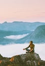 Man meditating in sunset mountains yoga relaxing Royalty Free Stock Photo